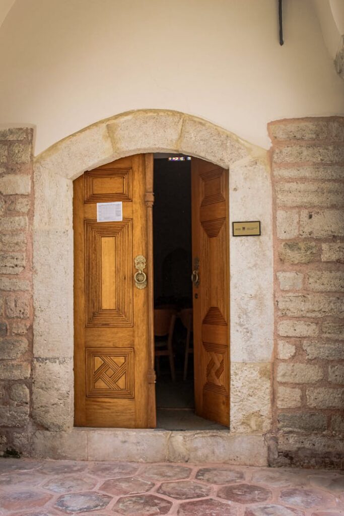 Charming wooden door set in a stone archway in Istanbul, Türkiye, inviting exploration.